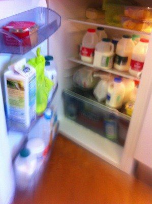 An office fridge full of single pints of milk